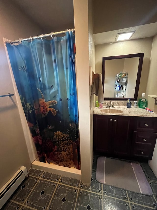 bathroom featuring vanity, a baseboard heating unit, a skylight, tile patterned flooring, and walk in shower