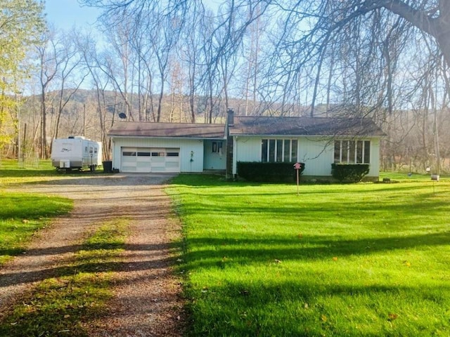 ranch-style house with a front yard and a garage