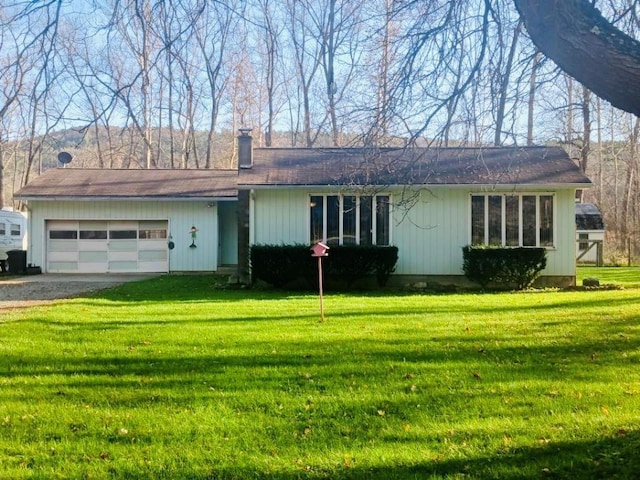 single story home featuring a garage and a front yard