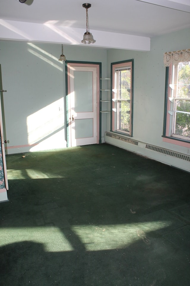 unfurnished room featuring plenty of natural light and a baseboard heating unit