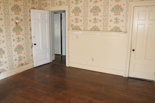 unfurnished room with dark hardwood / wood-style floors