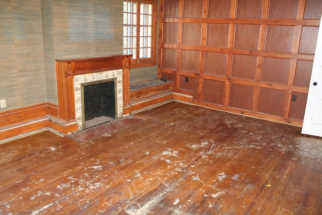 unfurnished living room with dark hardwood / wood-style flooring and a fireplace