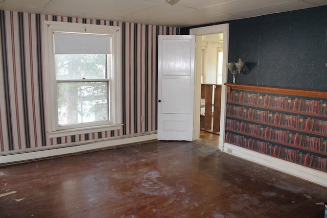 unfurnished room featuring baseboard heating