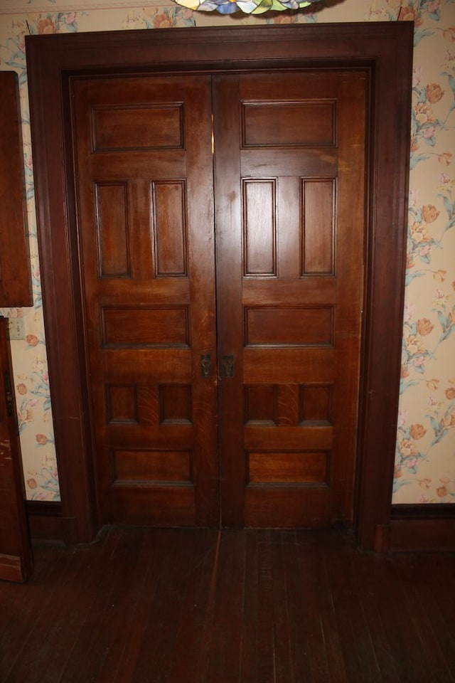 corridor with french doors and dark hardwood / wood-style flooring