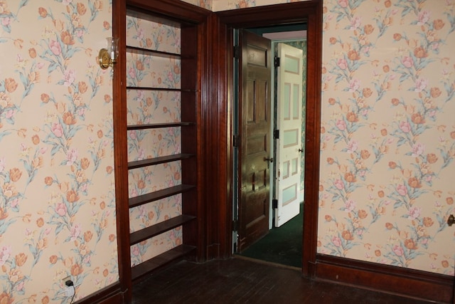 hallway with dark hardwood / wood-style floors