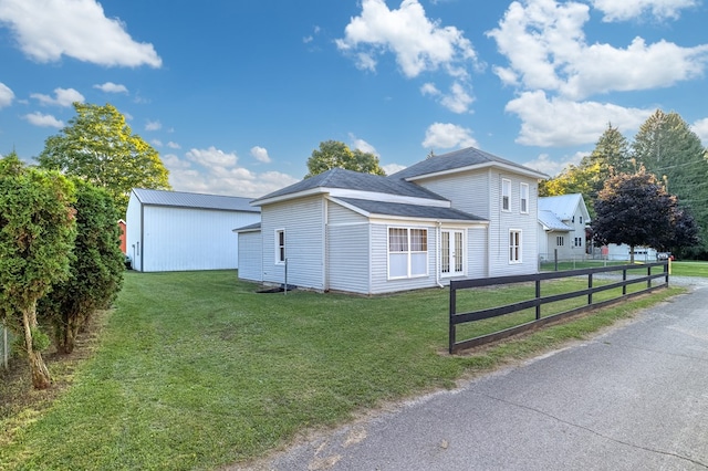 view of side of property featuring a yard