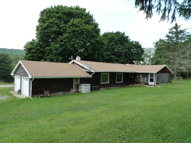 view of front of home with a garage and a front yard