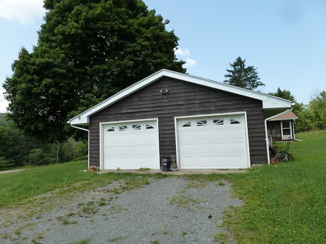 garage featuring a lawn