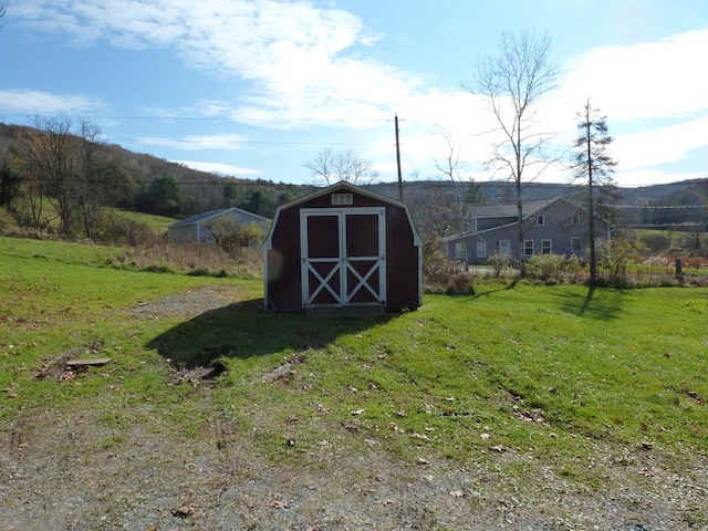 view of outbuilding featuring a yard