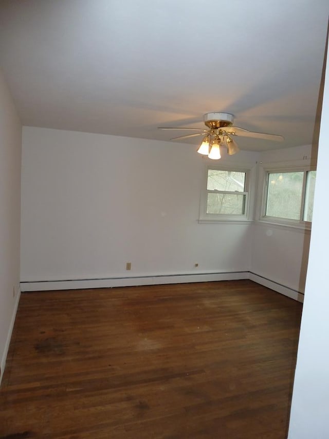 empty room with dark hardwood / wood-style floors and ceiling fan