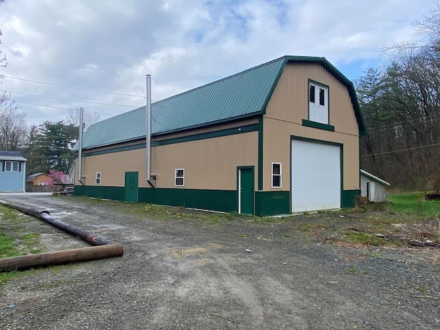 view of side of property with an outbuilding and a garage