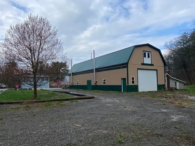 view of side of property featuring an outdoor structure and a garage