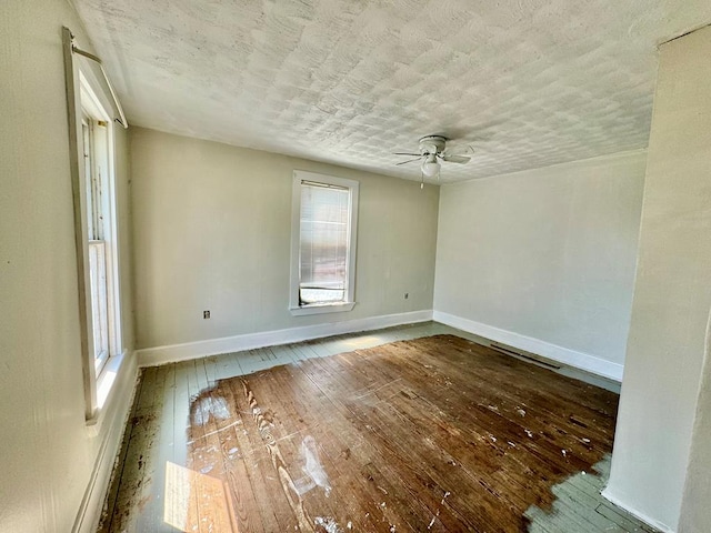 empty room with ceiling fan and hardwood / wood-style floors