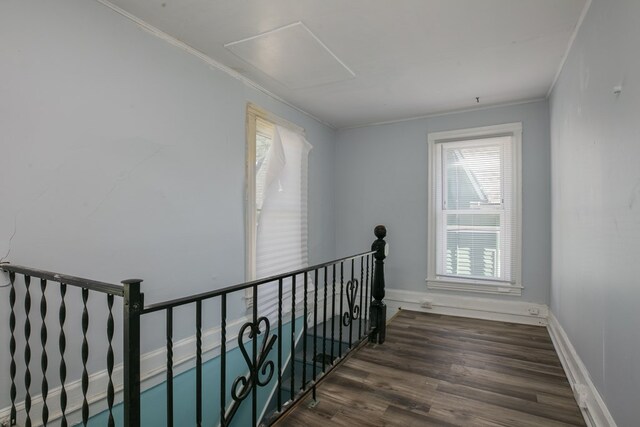 stairway with ornamental molding and hardwood / wood-style flooring