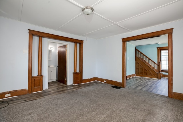 unfurnished room with dark carpet