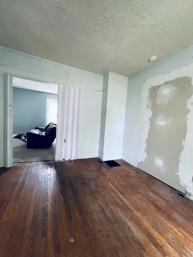 empty room featuring hardwood / wood-style floors and a textured ceiling