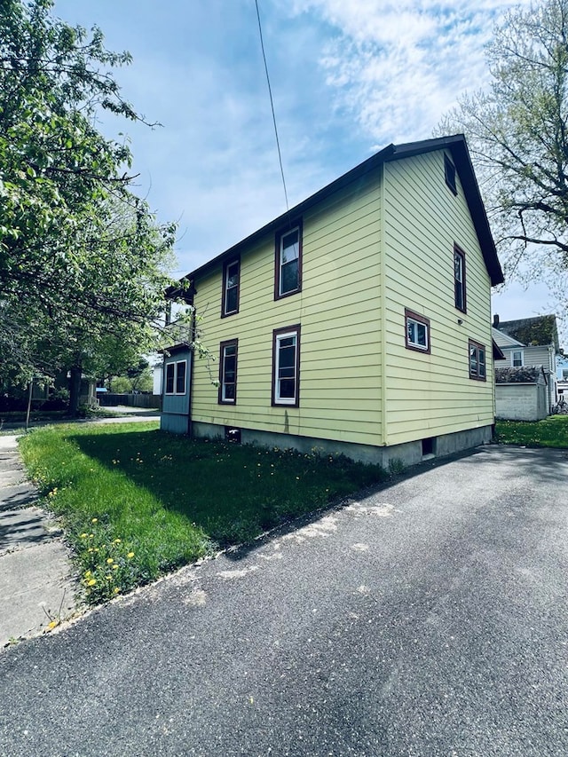 view of home's exterior with a yard