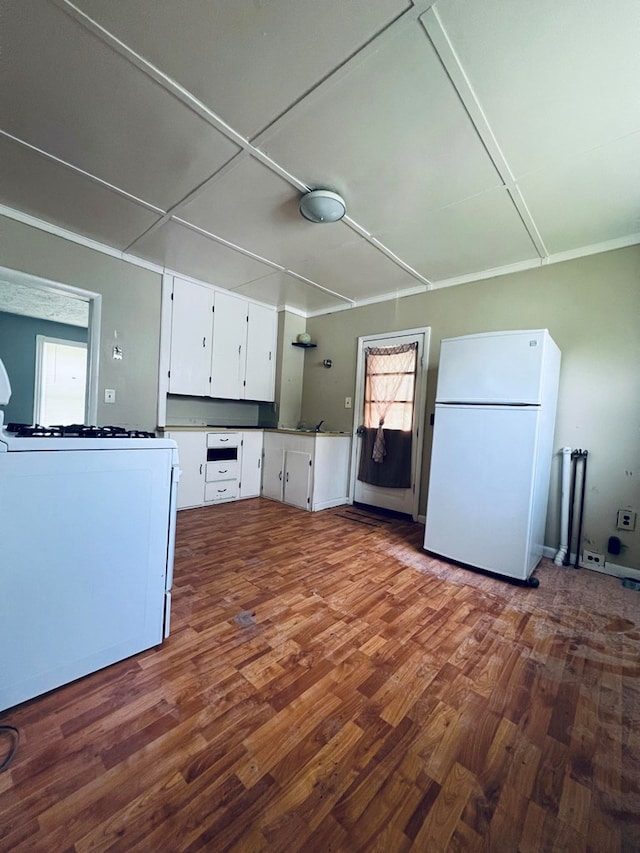 kitchen with white cabinets, white appliances, and dark wood-type flooring