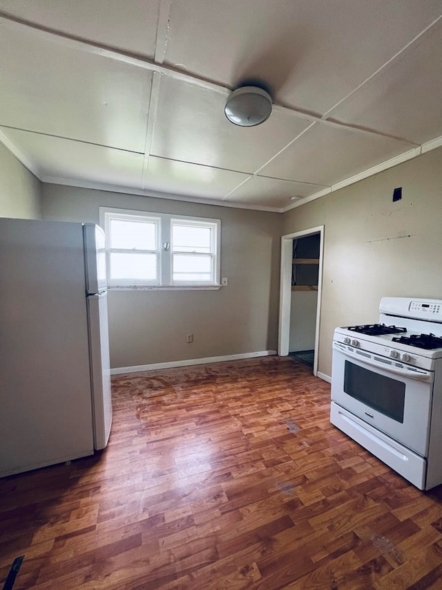 kitchen featuring dark hardwood / wood-style floors and white appliances