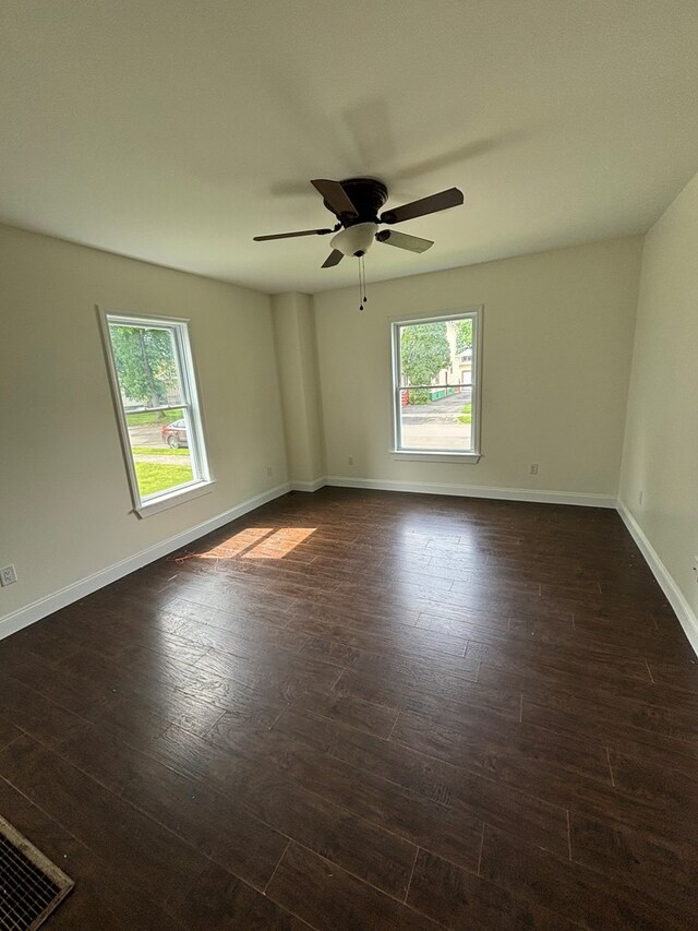 unfurnished room featuring ceiling fan and dark hardwood / wood-style floors