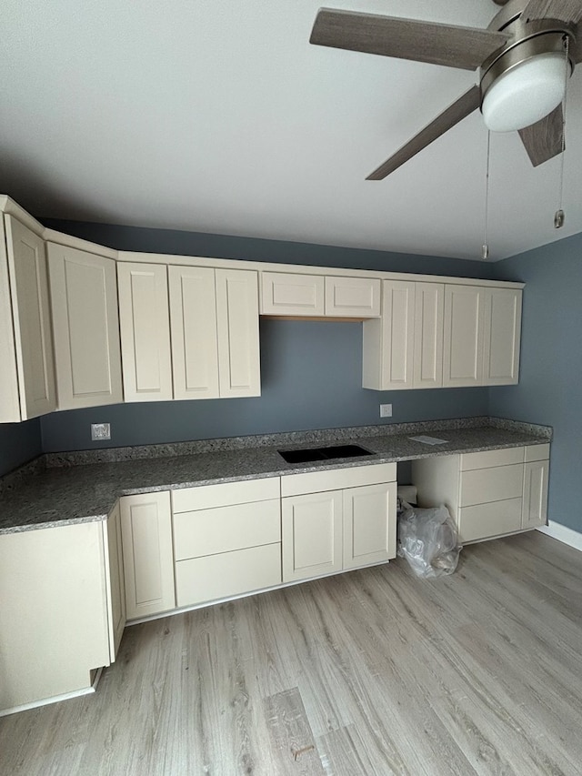 kitchen with ceiling fan, white cabinets, and light wood-type flooring