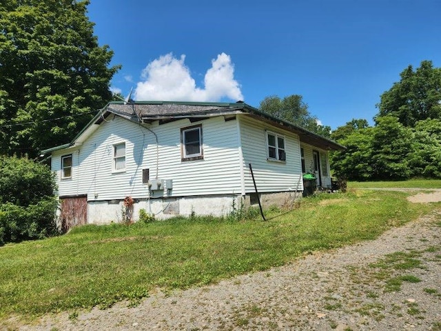 view of property exterior featuring a lawn