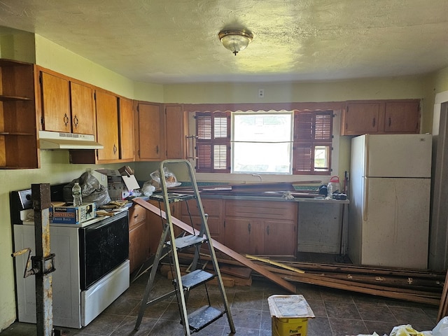 kitchen featuring white appliances and a textured ceiling