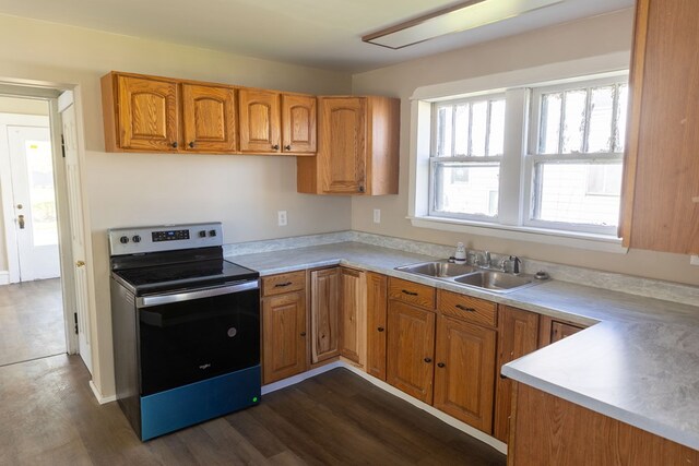 kitchen with dark hardwood / wood-style flooring, stainless steel range with electric stovetop, and sink