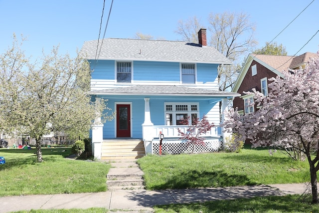 view of front facade with covered porch and a front yard