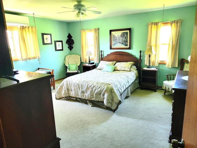 carpeted bedroom with a wall mounted air conditioner and ceiling fan