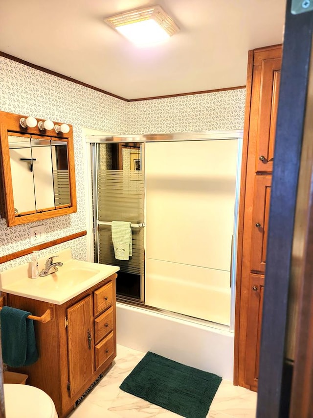 bathroom with vanity, crown molding, and enclosed tub / shower combo