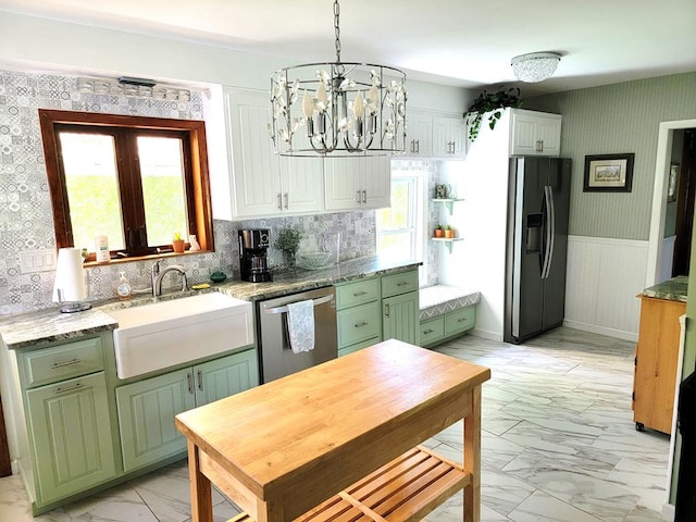 kitchen featuring green cabinets, sink, plenty of natural light, and appliances with stainless steel finishes