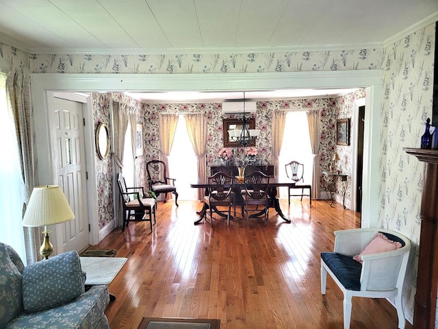 interior space featuring plenty of natural light, wood-type flooring, crown molding, and a wall mounted AC