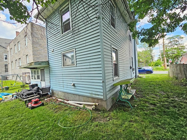 view of home's exterior with a lawn