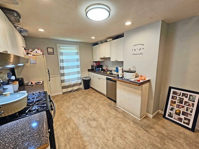 kitchen featuring sink, gas range, a textured ceiling, stainless steel dishwasher, and white cabinets