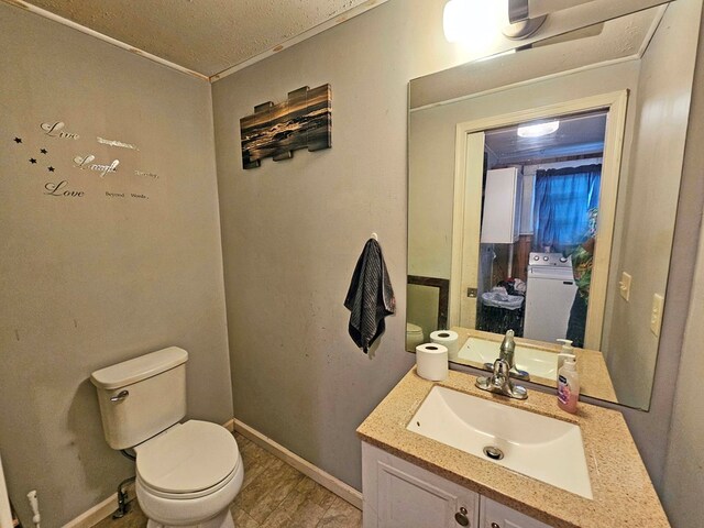 bathroom featuring vanity, hardwood / wood-style floors, ornamental molding, and toilet