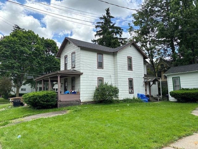 view of front of home with a front yard and a porch