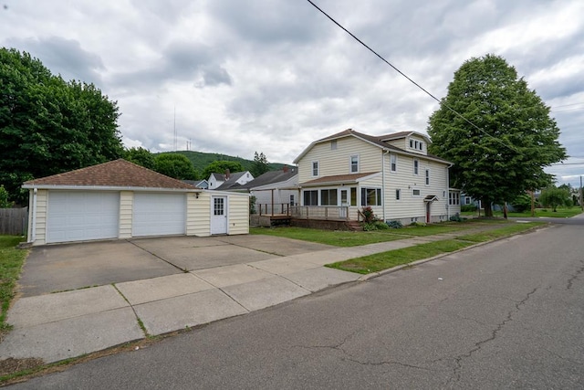 view of front of property with a garage and an outbuilding