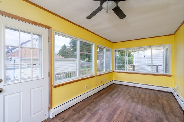 unfurnished sunroom featuring ceiling fan, plenty of natural light, and a baseboard heating unit