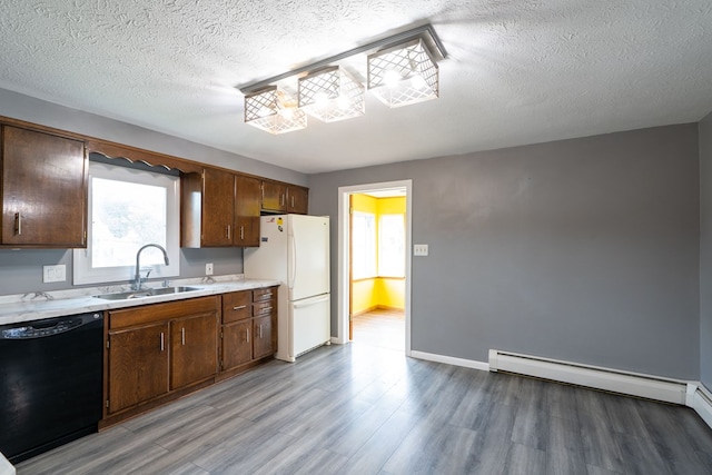 kitchen featuring light wood-type flooring, a textured ceiling, sink, black dishwasher, and white fridge