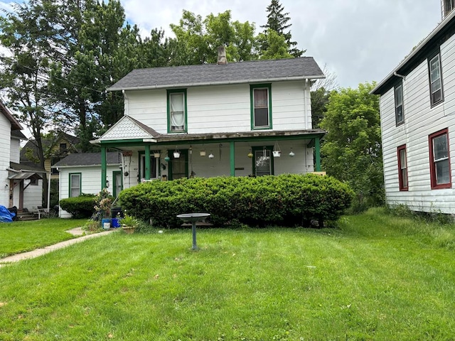 view of front of house featuring covered porch and a front yard