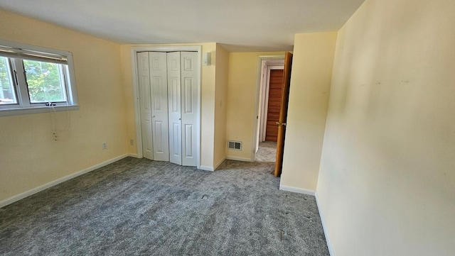 unfurnished bedroom with carpet floors and a closet