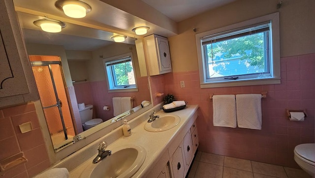 bathroom with vanity, tile walls, tile patterned flooring, and toilet