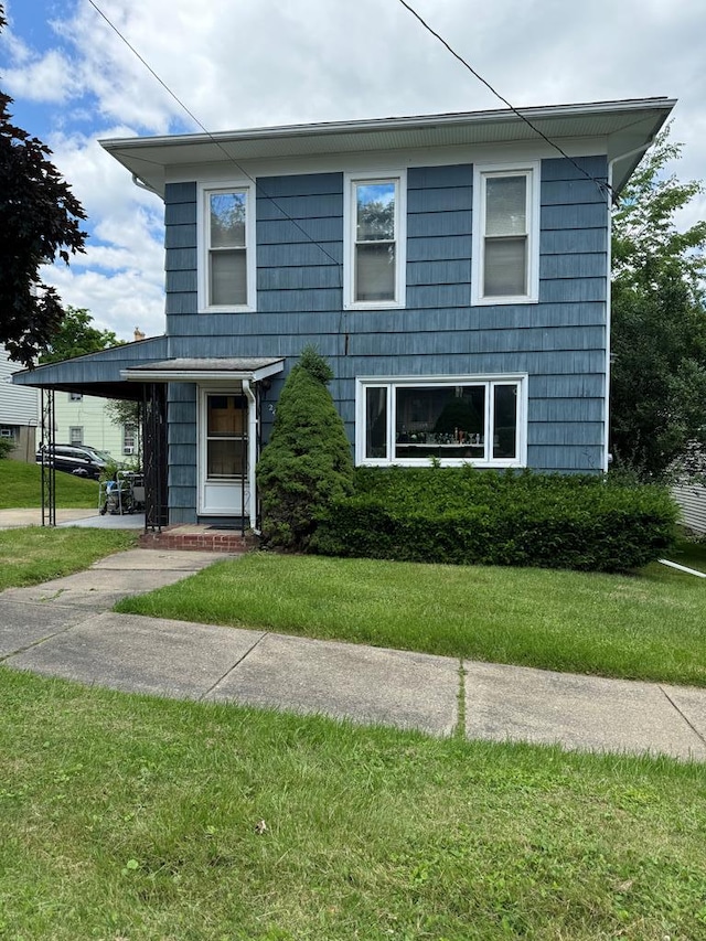 view of property featuring a front yard