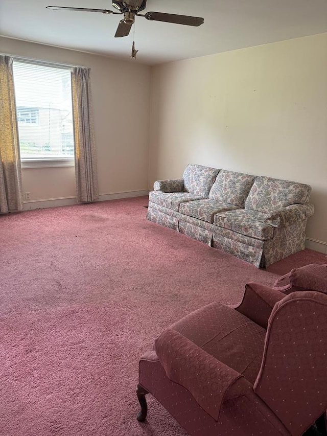 carpeted living room with ceiling fan