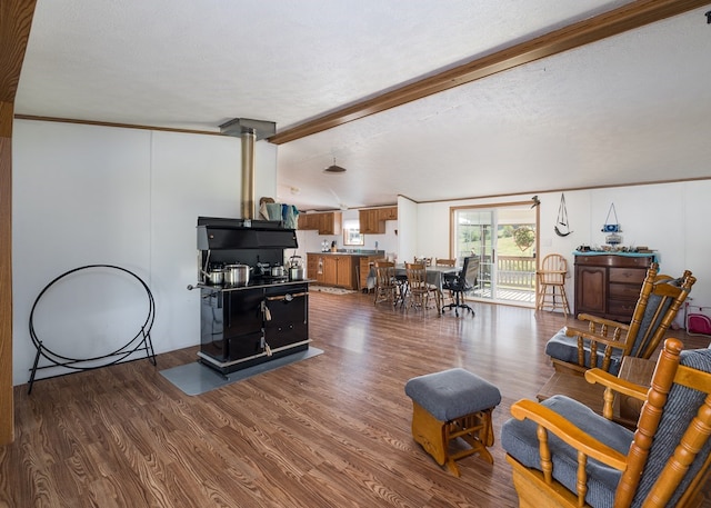 living room with a textured ceiling, beamed ceiling, and dark hardwood / wood-style floors