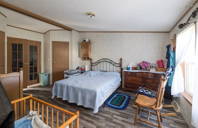 bedroom with crown molding, dark wood-type flooring, and french doors