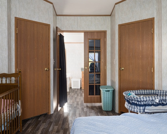 bedroom with dark hardwood / wood-style floors and ornamental molding