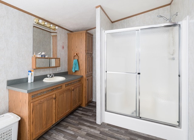 bathroom with a shower with door, ornamental molding, and hardwood / wood-style floors