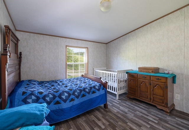 bedroom with crown molding and dark hardwood / wood-style flooring